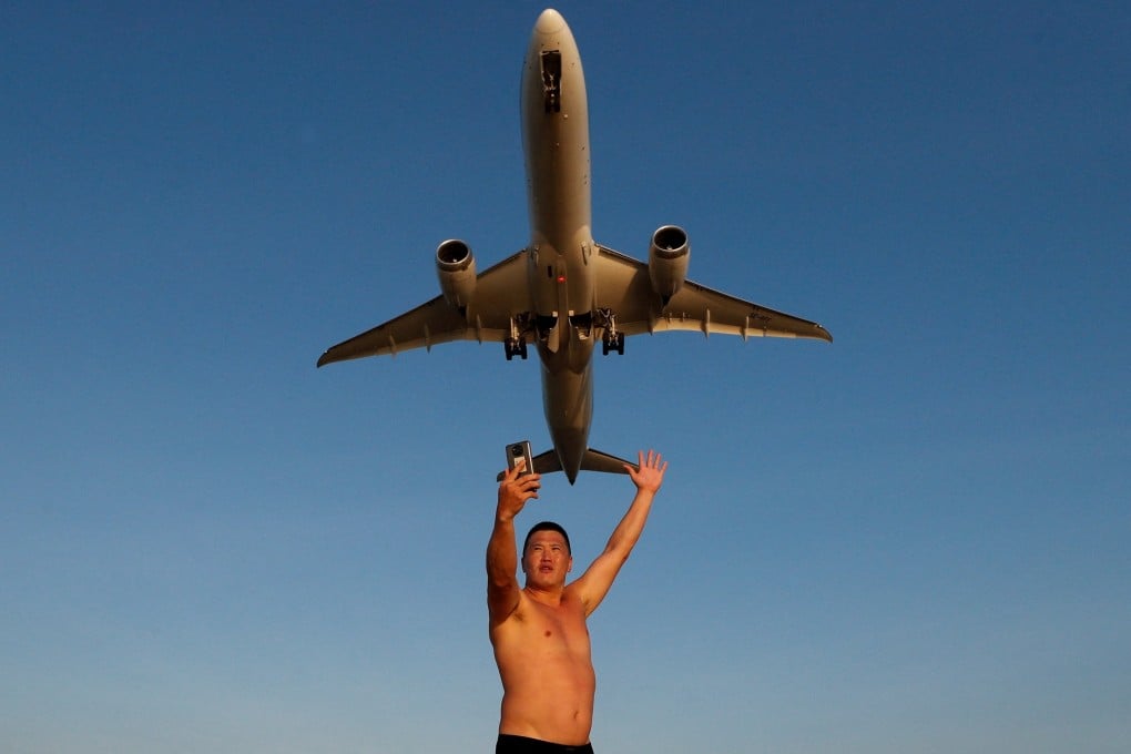 A Russian tourist takes a selfie at Mai Khao beach in Phuket, Thailand. File photo: Reuters