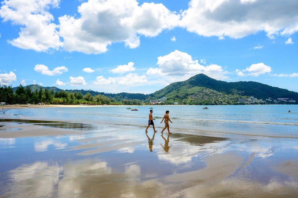 Tourists walk on a beach on the Thai island of Phuket last year. Photo: AFP