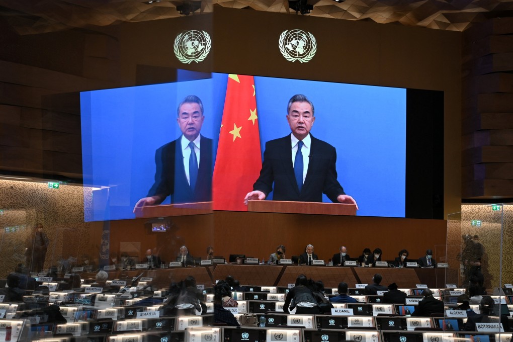 Chinese Foreign Minister Wang Yi appears on a screen as he delivers a speech at the opening of a session of the UN Human Rights Council, following the Russian invasion of Ukraine. Photo: Reuters