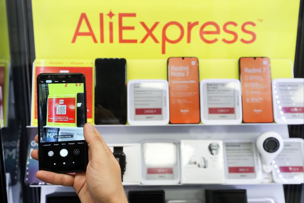 In this file photo dated August 8, 2019, an online retailer in Russia displays products in front of an AliExpress sign. Photo: Tass via Getty Images