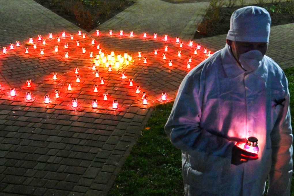 An employee takes part in a memorial ceremony marking the 35th anniversary of the 1986 Chernobyl disaster, in April 2021. Photo: AFP