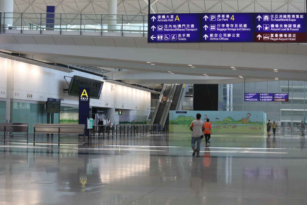 The arrivals hall at Hong Kong International Airport sits bereft of arrivals. Hongkongers stranded overseas by flight bans are forced into a choice between expensive “washout” periods in third countries or remaining overseas until the bans are lifted. Photo: Xiaomei Chen