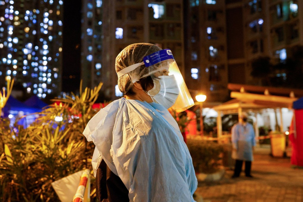 A worker outside a makeshift Hong Kong testing centre in a residential area under temporary lockdown. Photo: Reuters