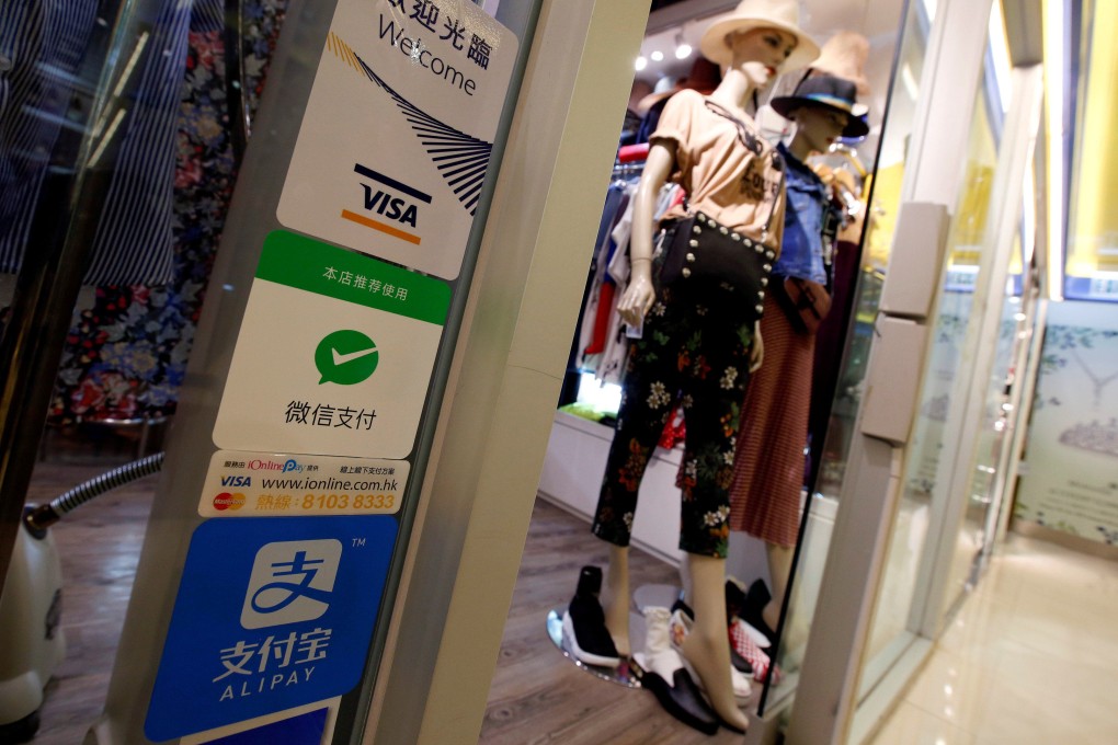 A shop displays digital payment services in Hong Kong. Only HK$53 million was allocated to fintech in this year’s budget. Photo: Reuters