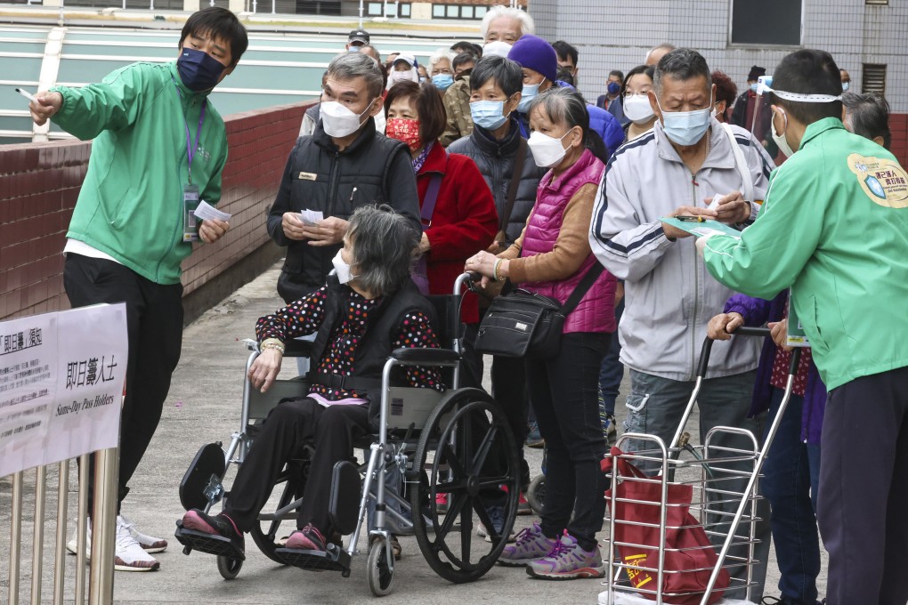 People queue outside a pop-up community vaccination centre at Tuen Mun Town Hall last month. Photo: K. Y. Cheng