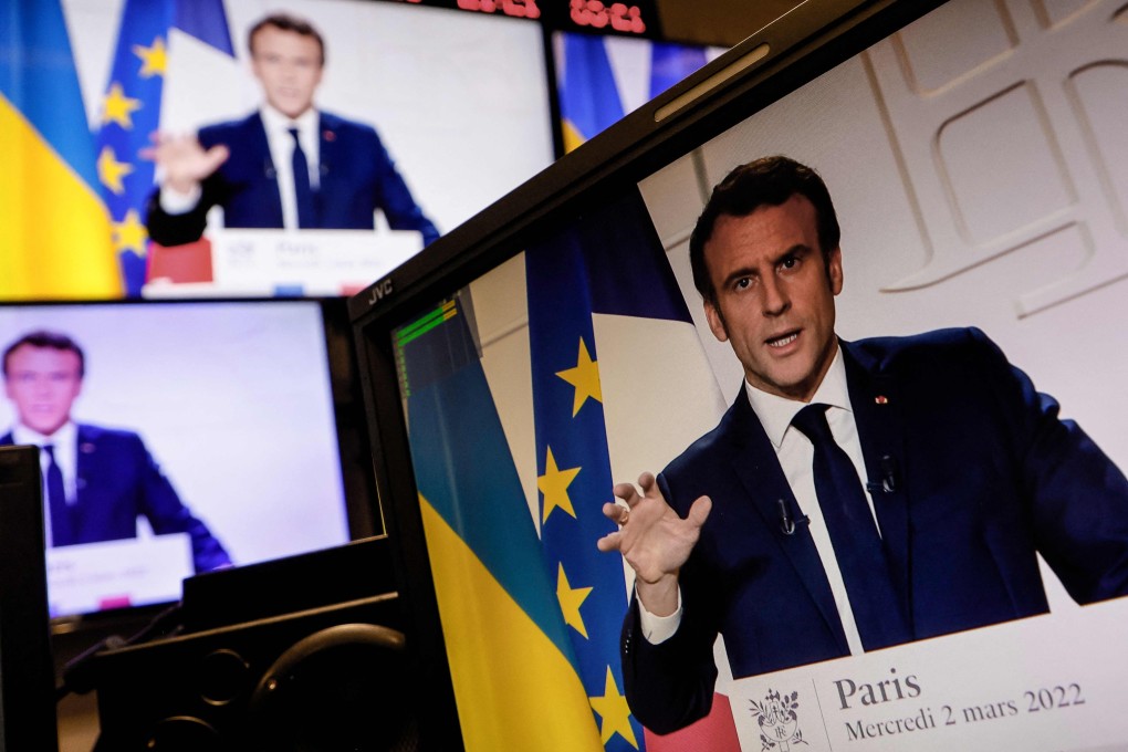 French President Emmanuel Macron is seen on multiple screens speaking from the Elysee Palace on Wednesday during a televised address on the general situation seven days after Russia invaded Ukraine. Photo: AFP