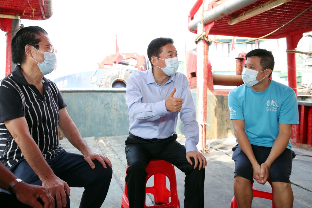 Luo Huining (centre), the director of Beijing’s liaison office, visits fishermen in Aberdeen on September 30, 2021, as part of a listening tour. Photo: Handout