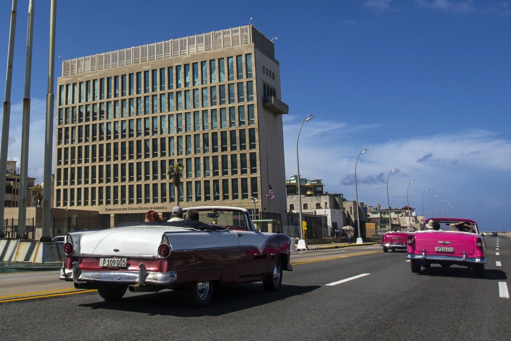Tourists ride in classic convertibles on the Malecon beside the US embassy in Havana in October 2017. Photo: AP