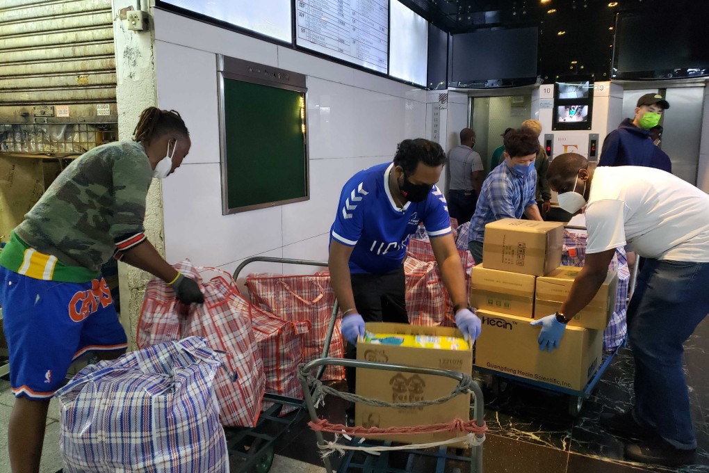 Staff at Christian Action’s Chungking Mansions office prepare the emergency relief packages for delivery to the needy. Photo: Jess Ma