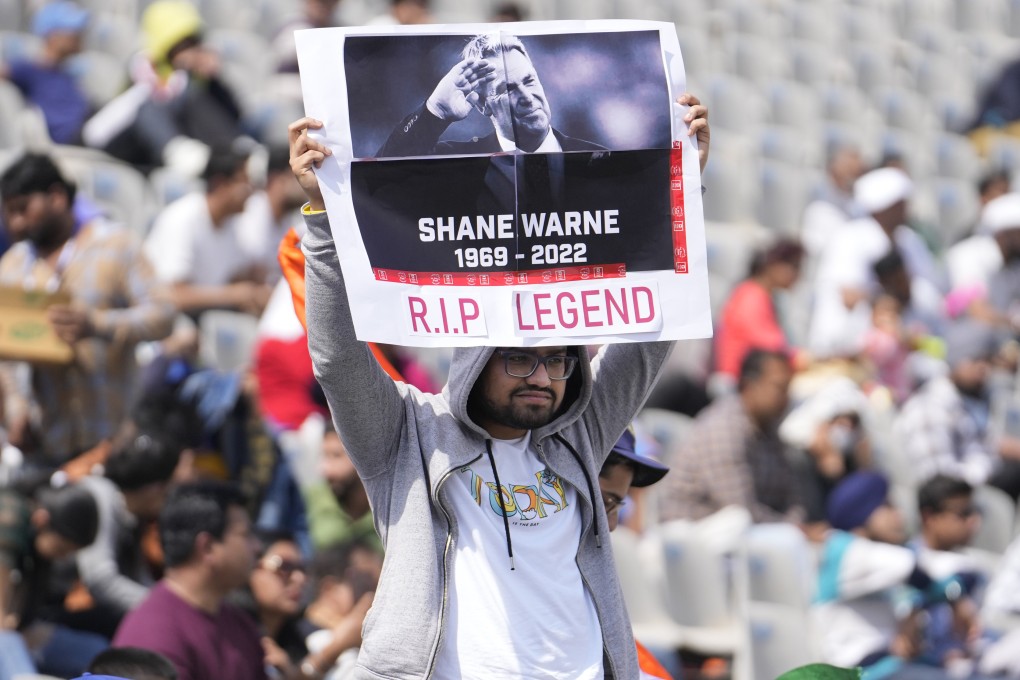 A cricket fan holds up a placard to pay tribute to Australian cricketer Shane Warne, in Mohali, India. Photo: AP