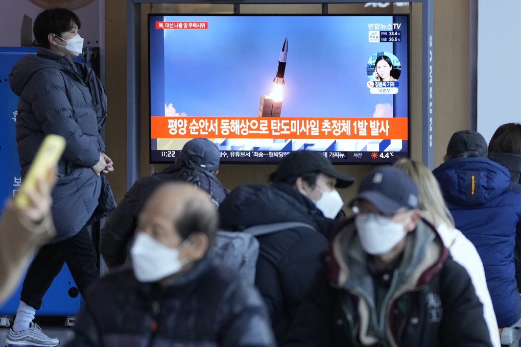 People watch a TV showing an image of North Korea’s missile launch during a news programme at Seoul Railway Station in Seoul, South Korea on March 5. Photo: AP