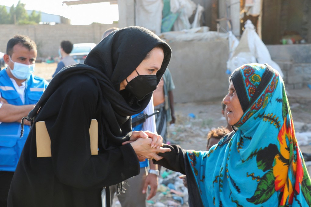 UNHCR special envoy Angelina Jolie shakes hands with a woman displaced by war during a visit to the southern province of Lahej, Yemen on March 6. Photo: Reuters