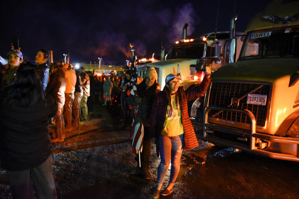 People participate in a rally while hundreds of vehicles are parked at Hagerstown Speedway, Maryland, before travelling to Washington to protest against coronavirus mandates on March 5. Photo: Reuters