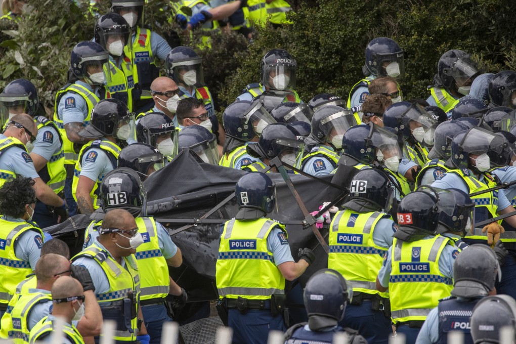 Police charge through a tent village set up by protesters opposing Covid-19 restrictions and vaccine mandates in Wellington, New Zealand, last week. Photo: Mark Mitchell/New Zealand Herald via AP