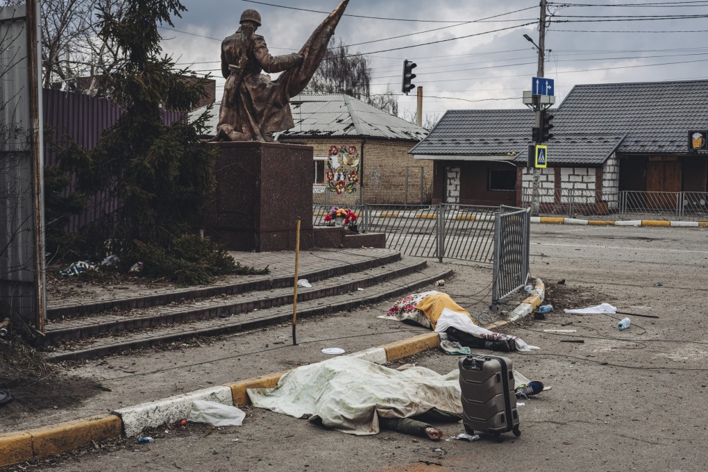 The dead bodies of people killed by Russian shelling lie covered in the street in the town of Irpin, Ukraine on Sunday. Photo: AP