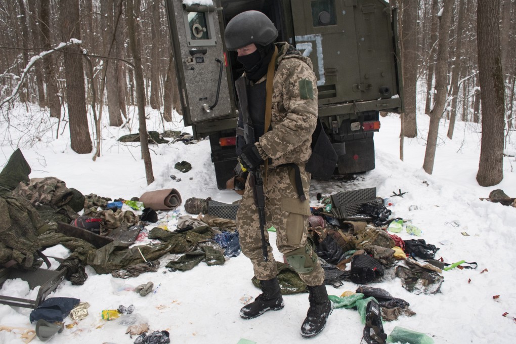 A volunteer for the Ukrainian Territorial Defence Forces inspects a damaged military vehicle on the outskirts Kharkiv, Ukraine’s second-largest city. Photo: AP