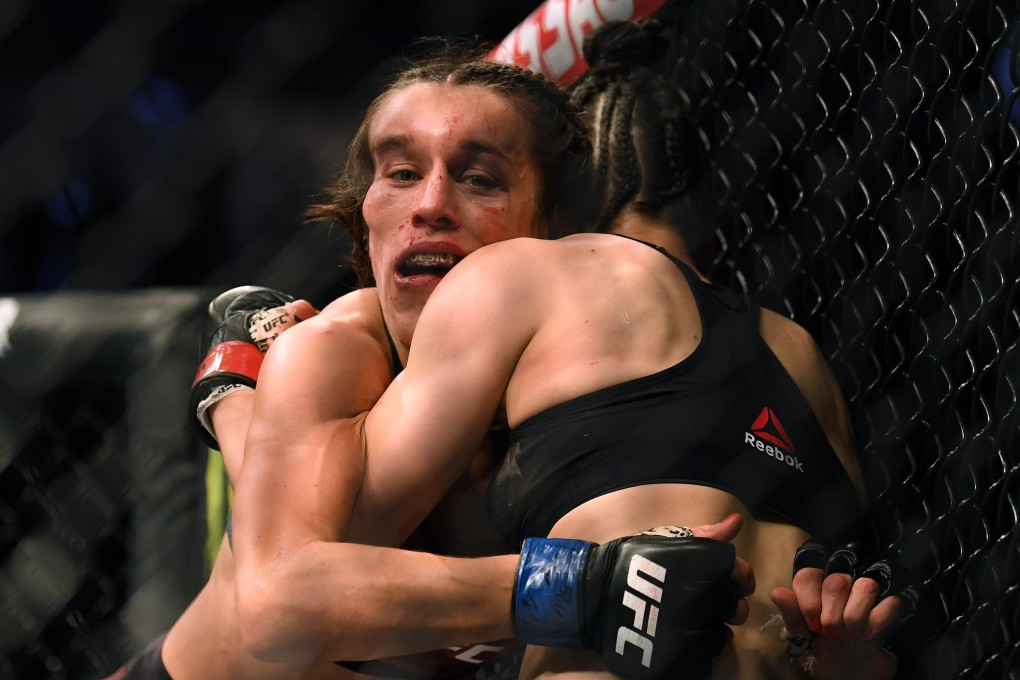 Joanna Jedrzejczyk hangs on to Zhang Weili during their strawweight title bout at T-Mobile Arena on March 7, 2020 in Las Vegas, Nevada. Photo: AFP