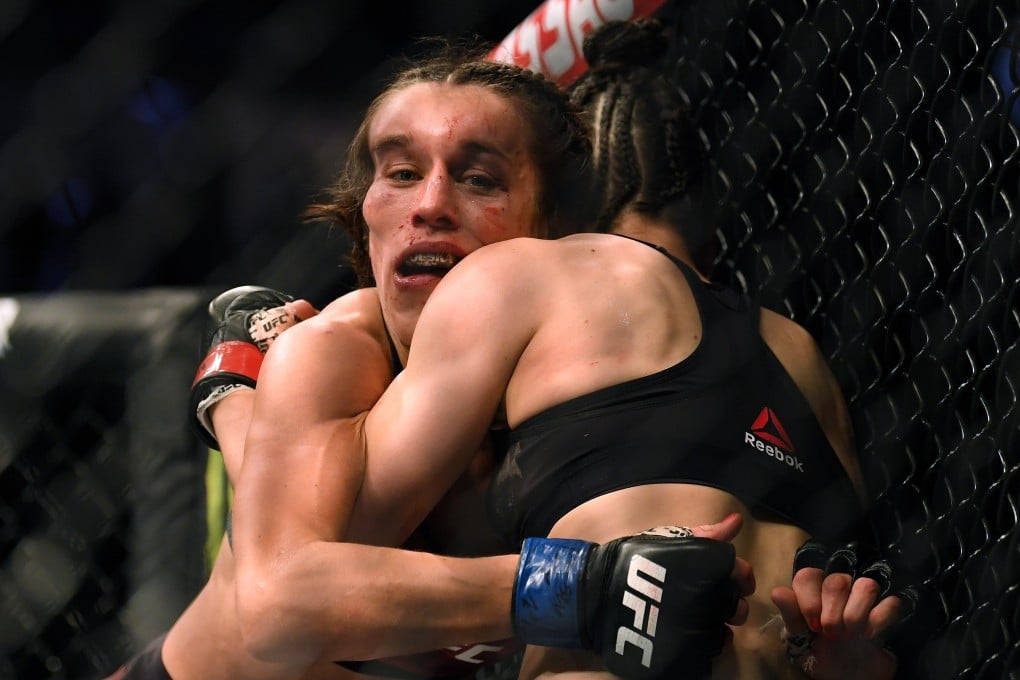 Joanna Jedrzejczyk hangs on to Zhang Weili during their strawweight title bout at T-Mobile Arena on March 7, 2020 in Las Vegas, Nevada. Photo: AFP