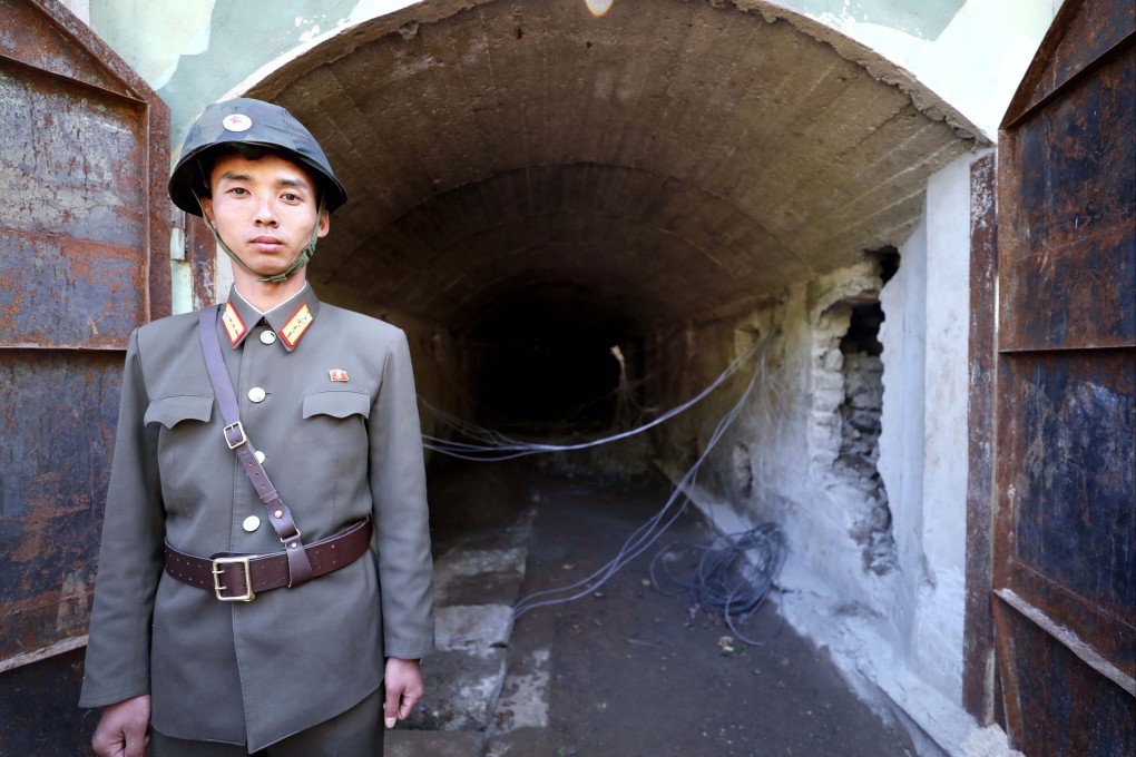A North Korean soldier stands guard at the entrance to a tunnel at the Punggye-ri nuclear test facility in 2018. Photo: News1 / Dong-a Ilbo via AFP