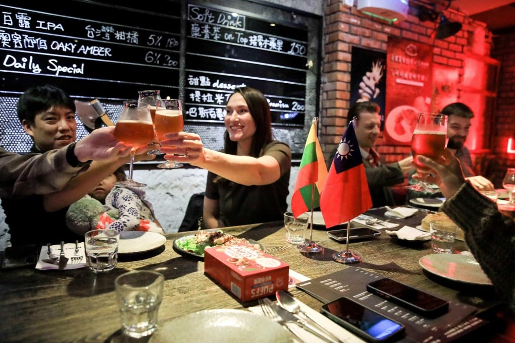 Members of the Lithuanian community in Taiwan celebrate their country’s Independence Day at a gathering in Taipei. Lithuanians find themselves applauded on the island after their nation stood up to Beijing last year. Photo: AFP