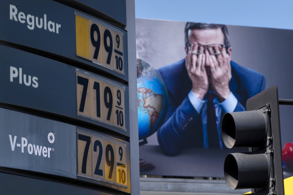 Petrol prices are seen in front of a billboard advertising HBO’s Last Week Tonight in Los Angeles on Monday. Photo: AP
