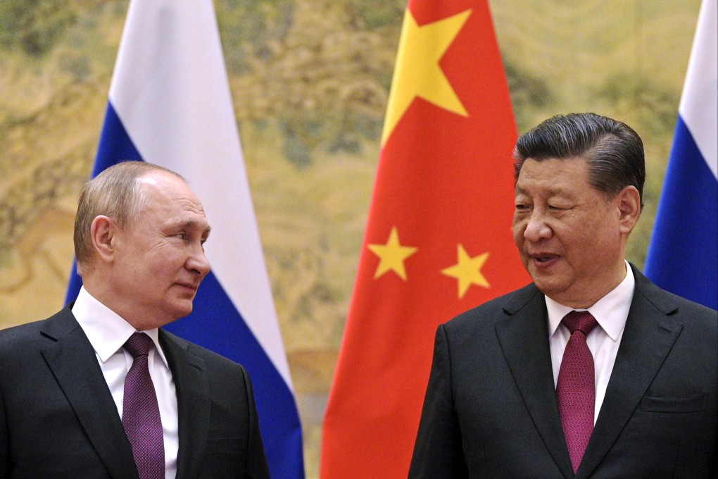 Russian President Vladimir Putin (left) and Chinese President Xi Jinping chat during their meeting in Beijing on February 4. Photo: AP