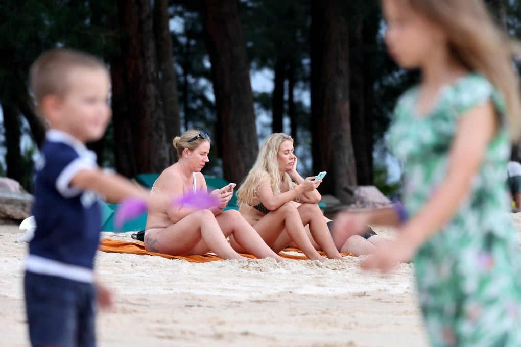 Russian tourists on a beach in Phuket this week. Thousands of their compatriots are stuck in Thailand, unable to find flights or pay for things because of Western sanctions on Russia for its invasion of Ukraine. Photo: Reuters