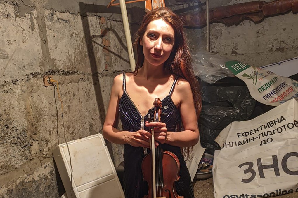 Vera Lytovchenko holds her violin as she poses for a photo in a basement of an apartment building in Kharkiv, Ukraine on Sunday. Photo: Vera Lytovchenko via AP