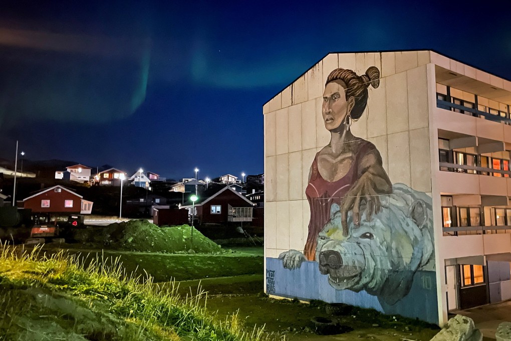 The Northern Lights are seen behind a mural on the side of a building in Nuuk, Greenland in September. Photo: Reuters