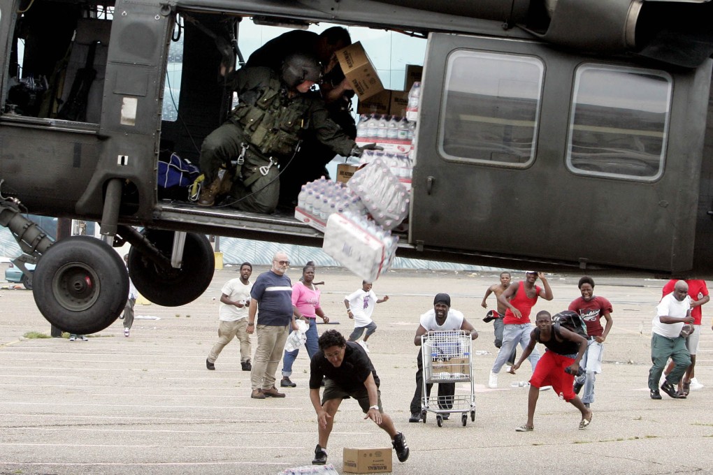 A military helicopter making a food and water drop to survivors of Hurricane Katrina in New Orleans in 2005. Juliette Kayyem says we are in the age of disasters and need to rethink how we deal with them. Photo: AP