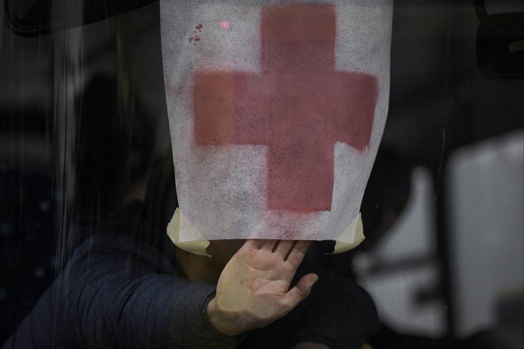 A man presses a paper with the red cross on it against the windshield of a bus as civilians are evacuated from Irpin, on the outskirts of Kyiv, Ukraine, on March 9. Photo: AP
