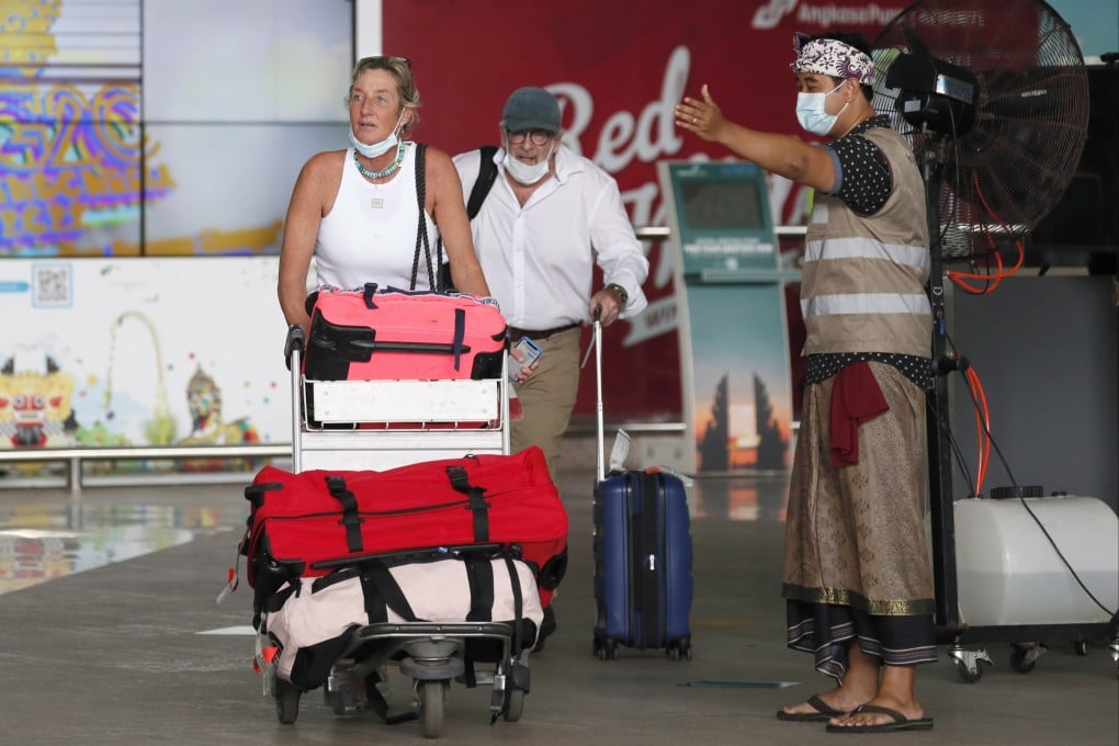 Foreign travellers are welcomed at Bali’s airport on Monday, the first day of quarantine-free entry for international passengers. Photo: EPA