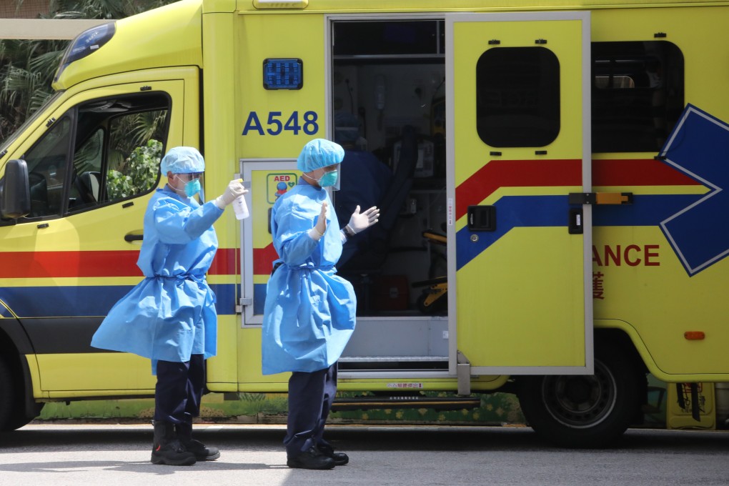 A paramedic sprays disinfectant on his colleague outside the accident and emergency department at the Queen Elizabeth Hospital in Jordan on February 28. Photo: Jelly Tse