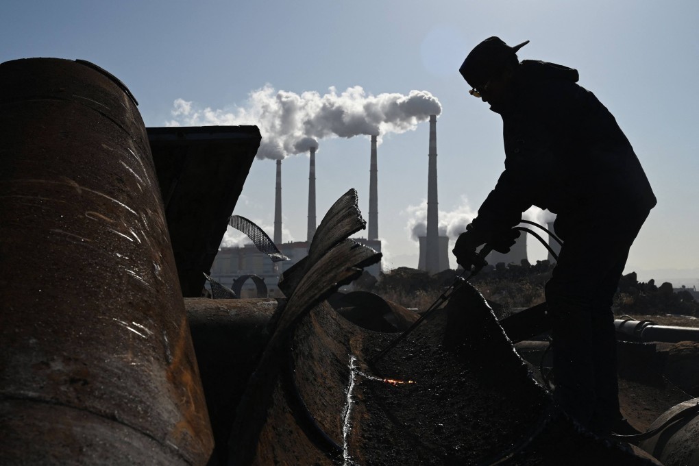 A worker cuts steel with a torch near the coal-powered Datang International Zhangjiakou Power Station in China’s northern Hebei province on November 12. Photo: AFP