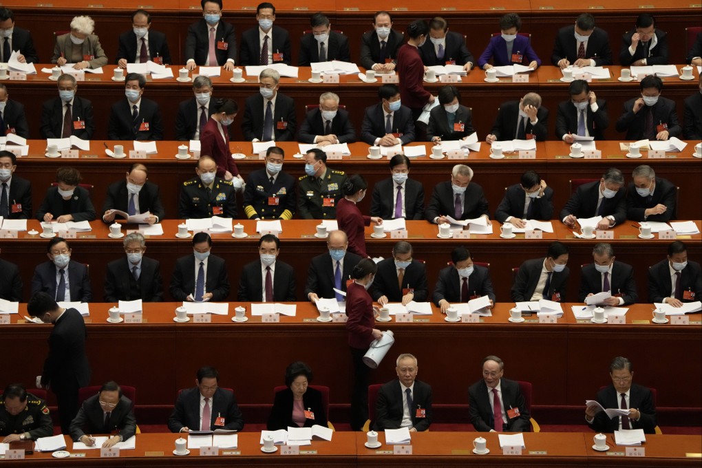 Hostesses pour drinks for delegates attending the opening ceremony of the National People’s Congress at the Great Hall of the People in Beijing on March 5. Photo: AP