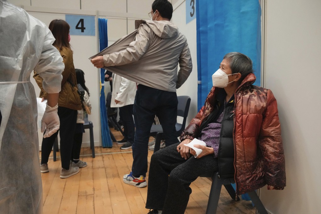 An elderly woman waits to receive a dose of Sinovac Covid-19 vaccine at a community vaccination center in Hong Kong. Photo: AP