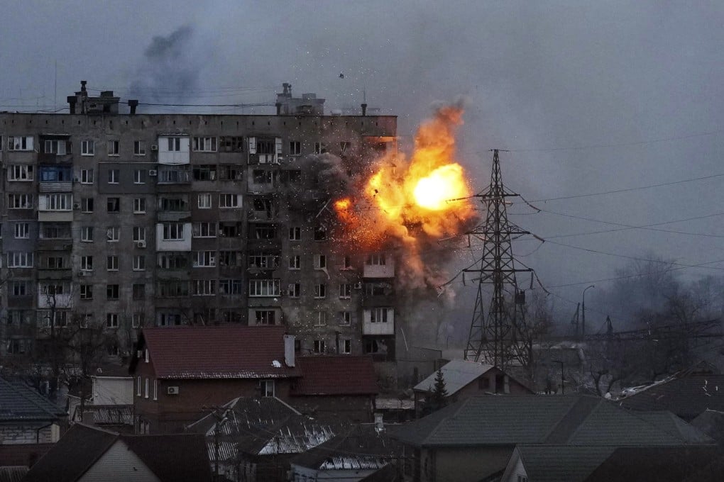 An explosion rips through a block of flats in Mariupol, Ukraine, after it was hit by Russian artillery fire on Friday. Photo: AP