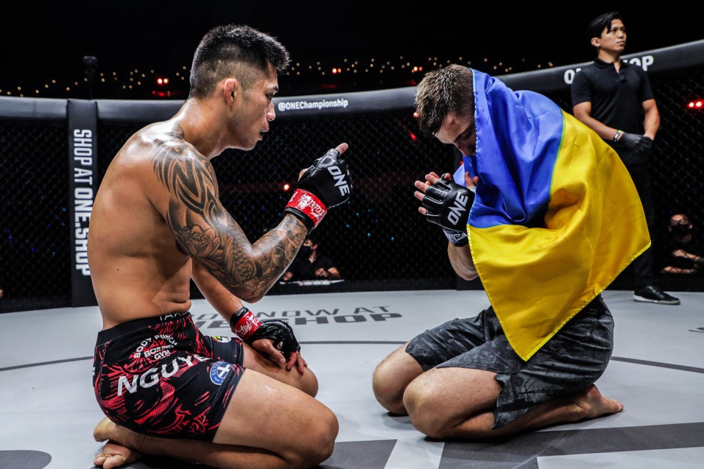 Martin Nguyen shares a moment of respect with Ukrainian fighter Kirill Grishenko after beating him at ONE: Lights Out. Photos: ONE Championship