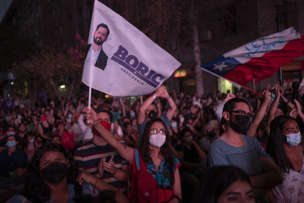 Supporters watch a speech by Gabriel Boric, the recently inaugurated president of Chile, in Santiago on Friday. Photo: EPA