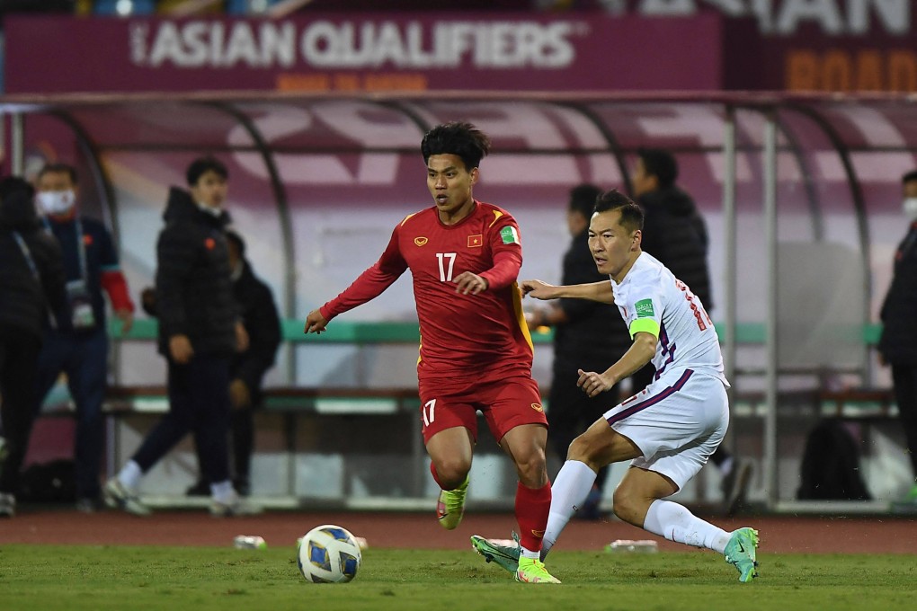 Vietnam’s Vu Van Thanh (left) runs past China’s Wu Xi during the FIFA World Cup qualifying round in Hanoi. Photo: AFP