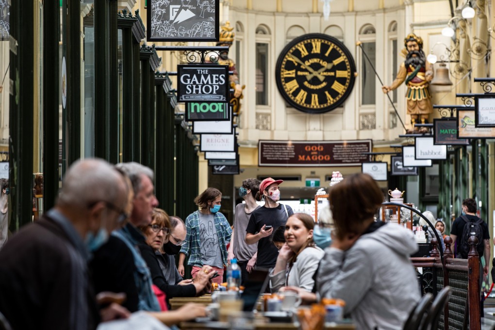 People sit at a cafe in Melbourne, Australia, on Friday. Photo: EPA