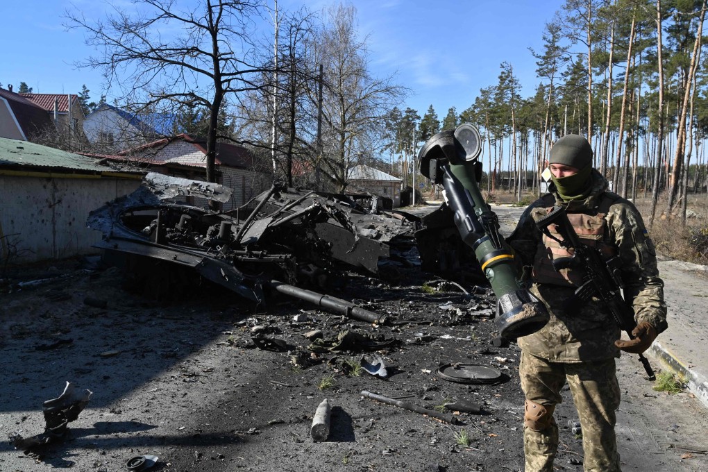 A Ukrainian soldier holds a Next Generation Light Anti-tank Weapon (NLAW) that was used to destroy a Russian armoured personal carrier (APC) in Irpin, north of Kyiv, on March 12. Photo: AFP