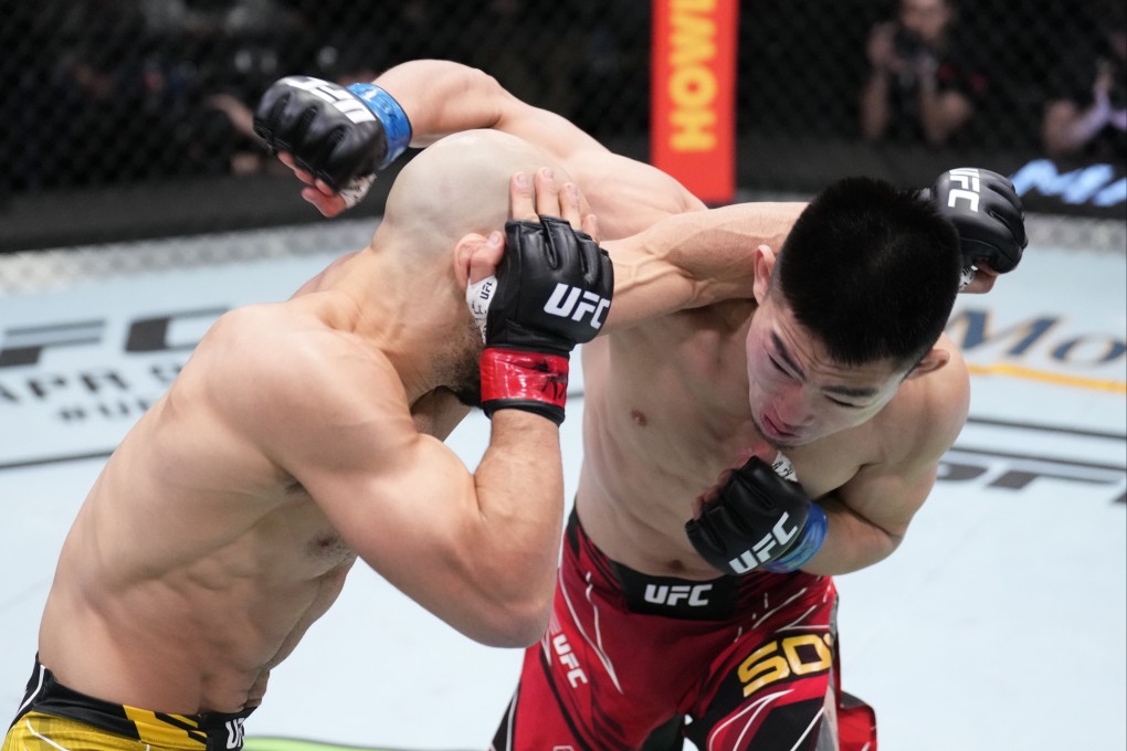 Song Yadong of China (right) and Marlon Moraes of Brazil trade punches in their bantamweight fight on March 12, 2022 in Las Vegas, Nevada. Photo: Chris Unger/Zuffa LLC