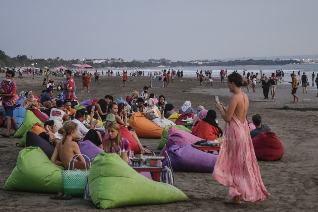 Tourists on Canggu Beach, Bali, Indonesia on March 12, 2022. The current requirements for foreign travellers to Bali have been criticised for being too much. Photo: Getty Images