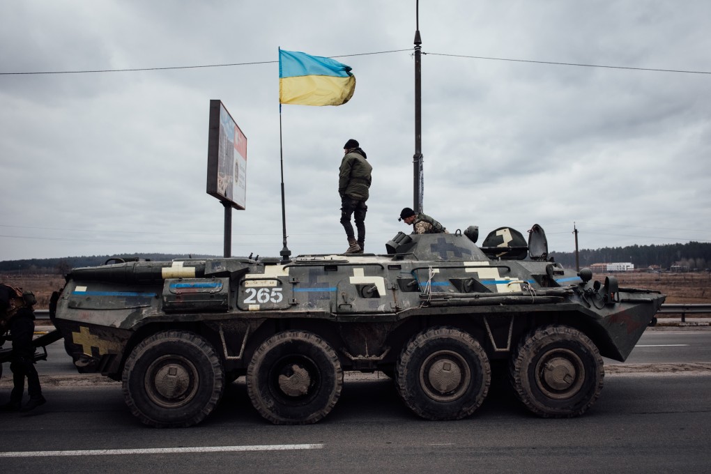 Ukrainian soldiers on their armoured vehicle at the entrance to the city of Irpin. The Ukrainian word for a type of bread is being used to identify Russian soldiers and saboteurs; Russian speakers articulate the word differently. Photo: Adrien Vautier / Le Pictorium Agency via Zuma / DPA