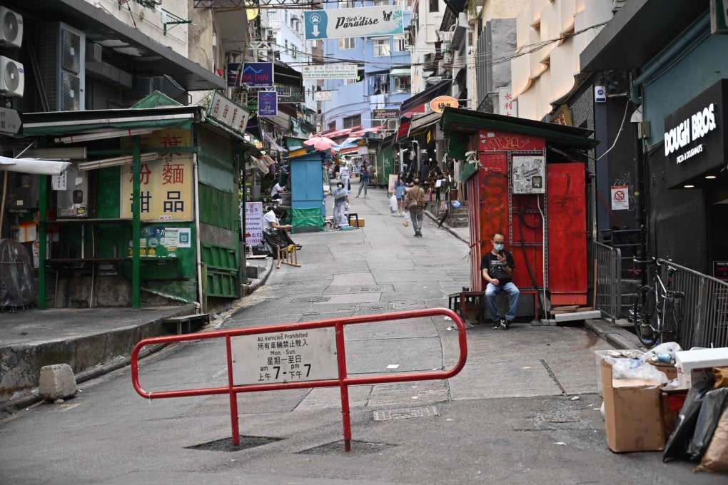 A man looks at his phone on an empty street in Hong Kong on Sunday. A minor earthquake shook parts of the city early Monday morning. Photo: AFP)