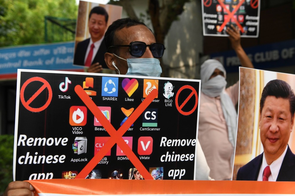 Protesters hold placards urging people to remove Chinese apps at a rally in New Delhi in June 2020. Photo: AFP