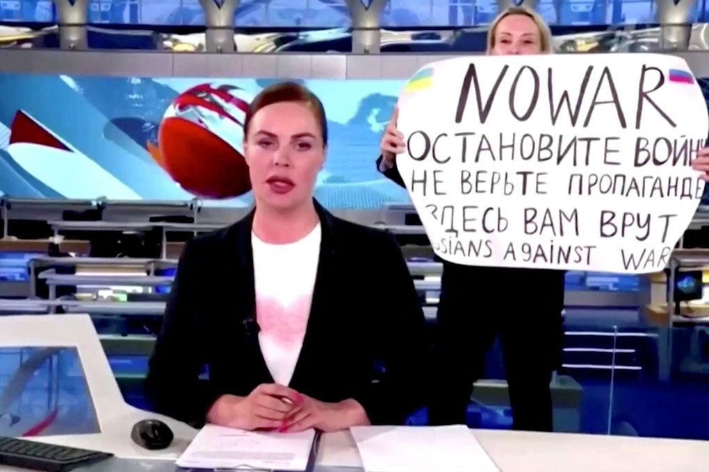 A woman interrupts a live news bulletin on Russia’s state TV ‘Channel One’ on Monday. Photo: Reuters