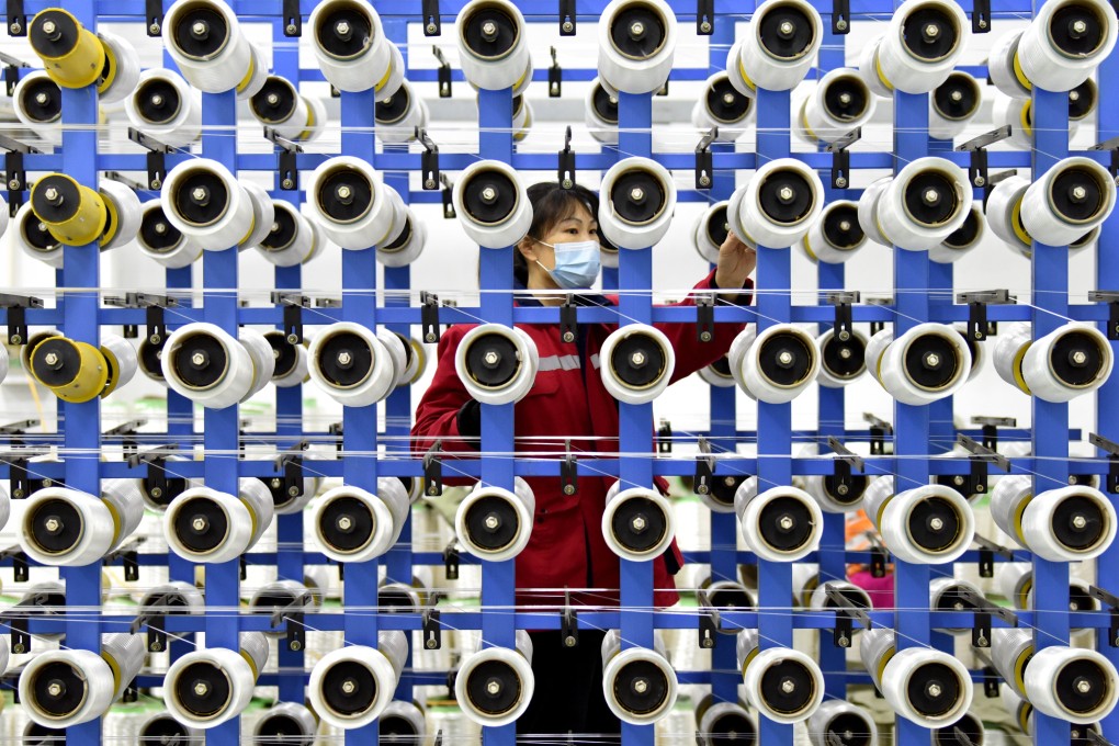 A woman works in the bulletproof UD fabric production workshop of a new material technology company in Hengshui city in Hebei province on November 30. The county has built technological industry clusters around new materials and equipment manufacturing. Photo: Xinhua