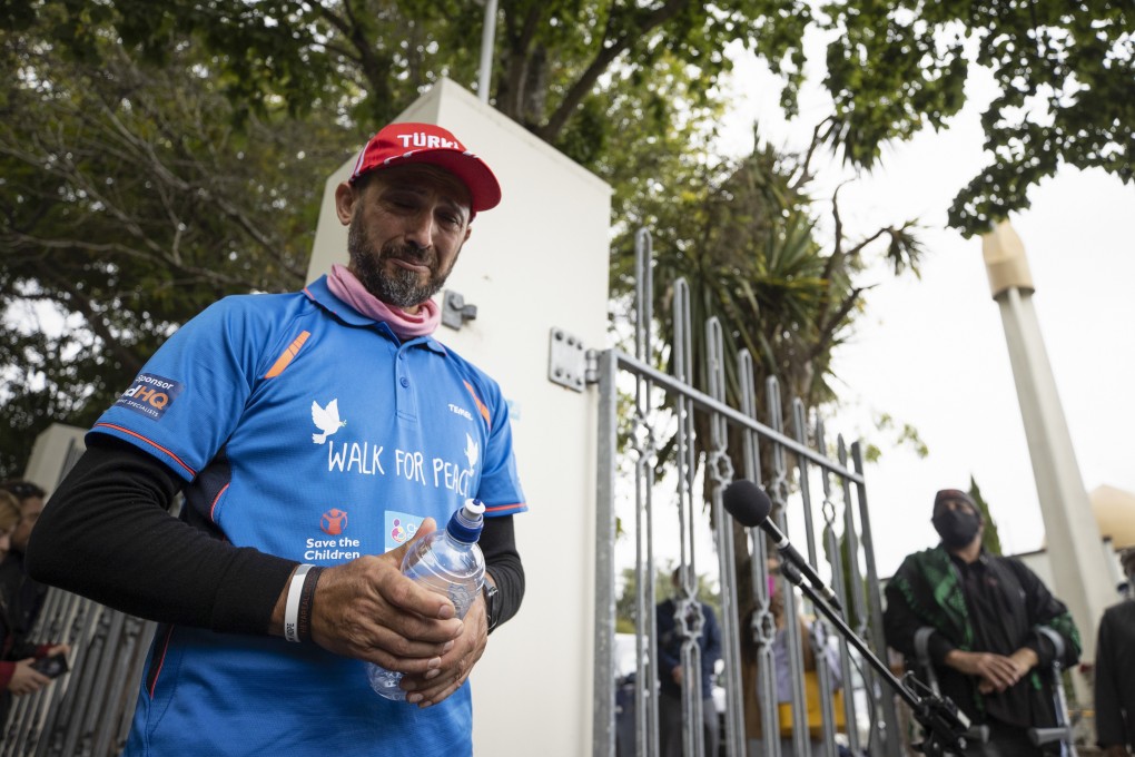 Al Noor Mosque shooting survivor Temel Atacocugu completes his walk from Dunedin to Christchurch on March 15, 2022. Photo: NZ Herald via AP